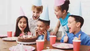 kids-birthday-party-boy-blowing-out-candles-on-cake-jpg